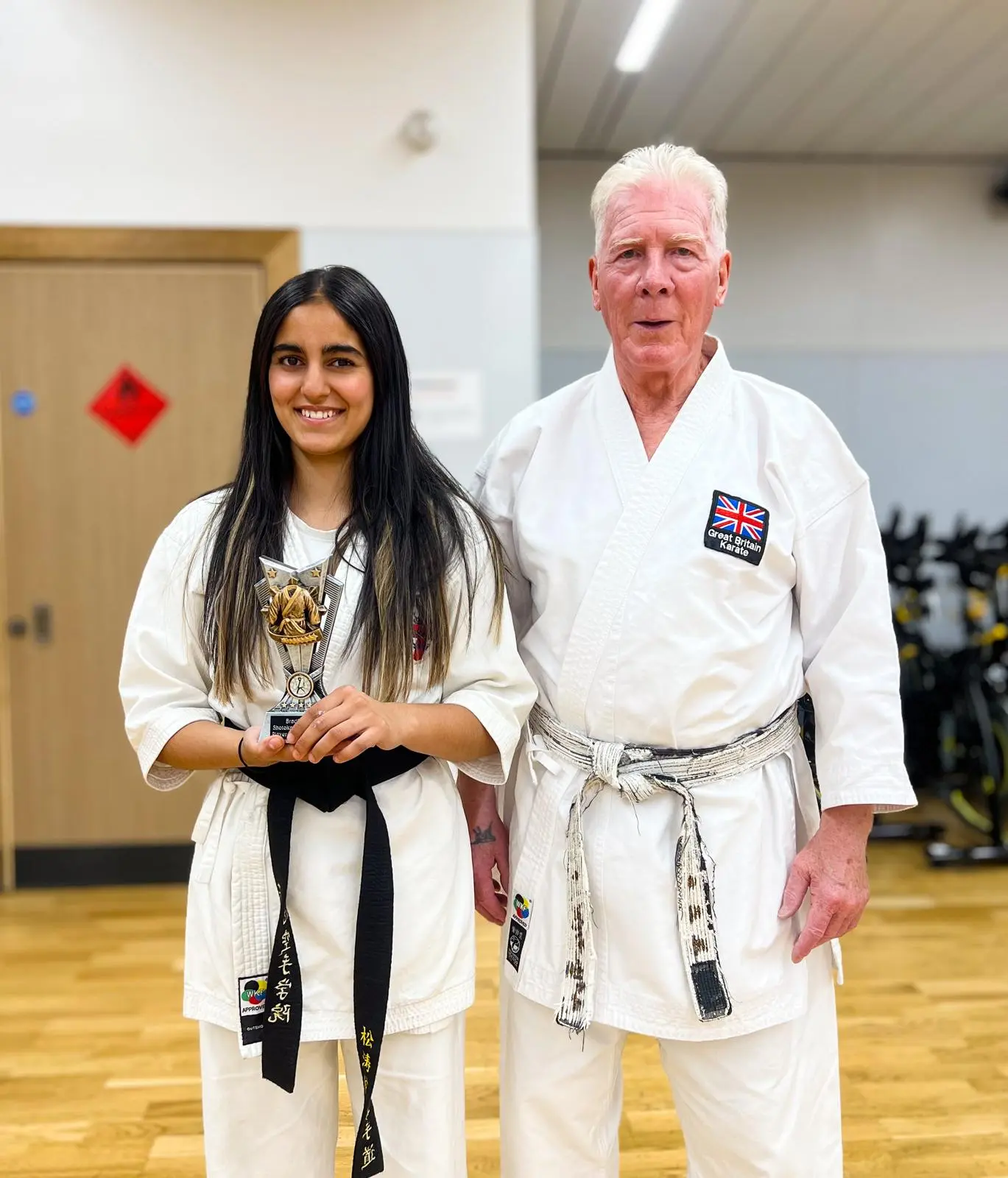Khudra accepts her trophy from Sensei Fred Fawcett