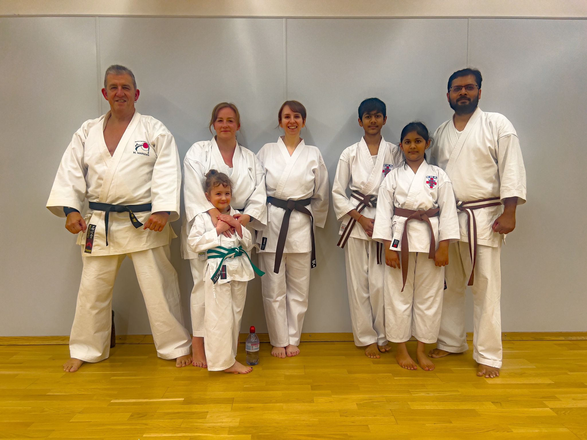 Two of the families that train at Bradford Shotokan Academy pose together in their karate gis after training