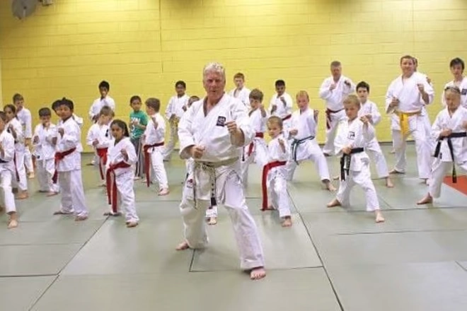 Sensei Fred Fawcett teaches karate to a school of students