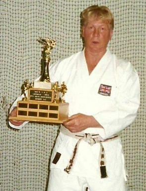 a younger Fred holding up his european championship trophy