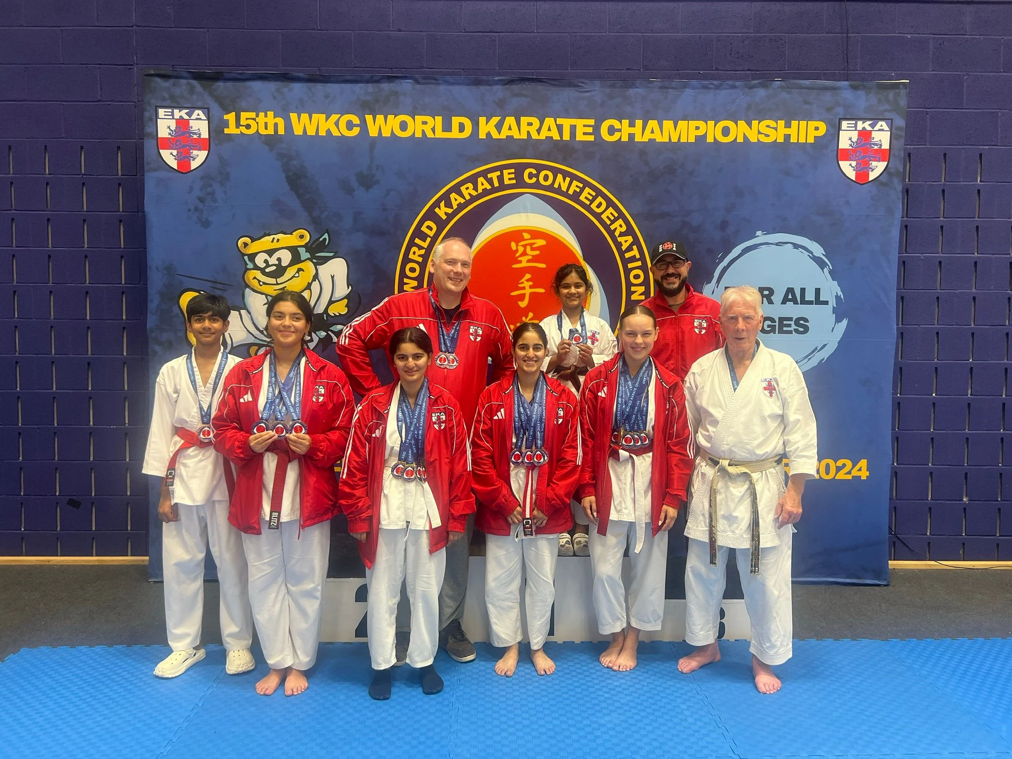 The Bradford Shotokan Academy squad line up on the podium to show the medals they won